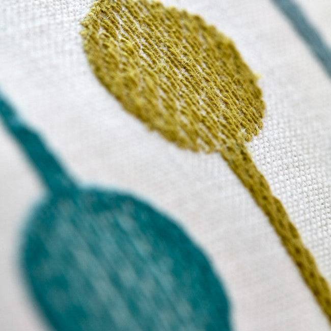 Close-up of Bayford Jade fabric showing detailed embroidery of textured yellow and teal circles. Premium textile for curtain and blind crafting.