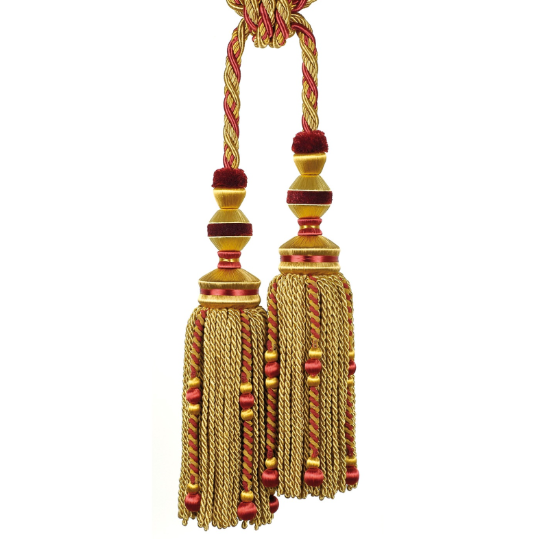 Decorative tassels with gold and red colors on a white background
