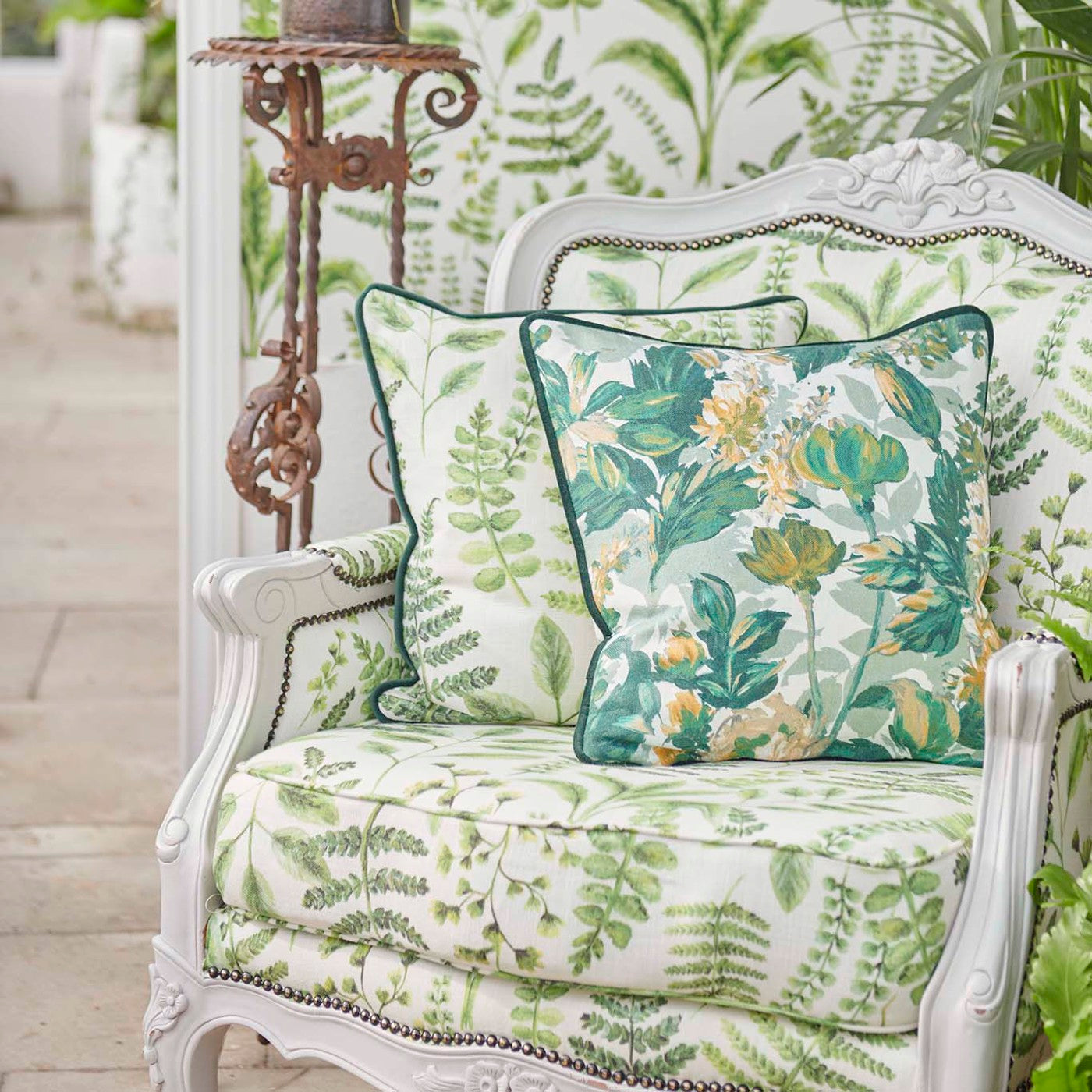 Elegant armchair adorned with Botanical Blooms Linen Glade floral fabric cushions and upholstery, set in a botanical-themed interior.
