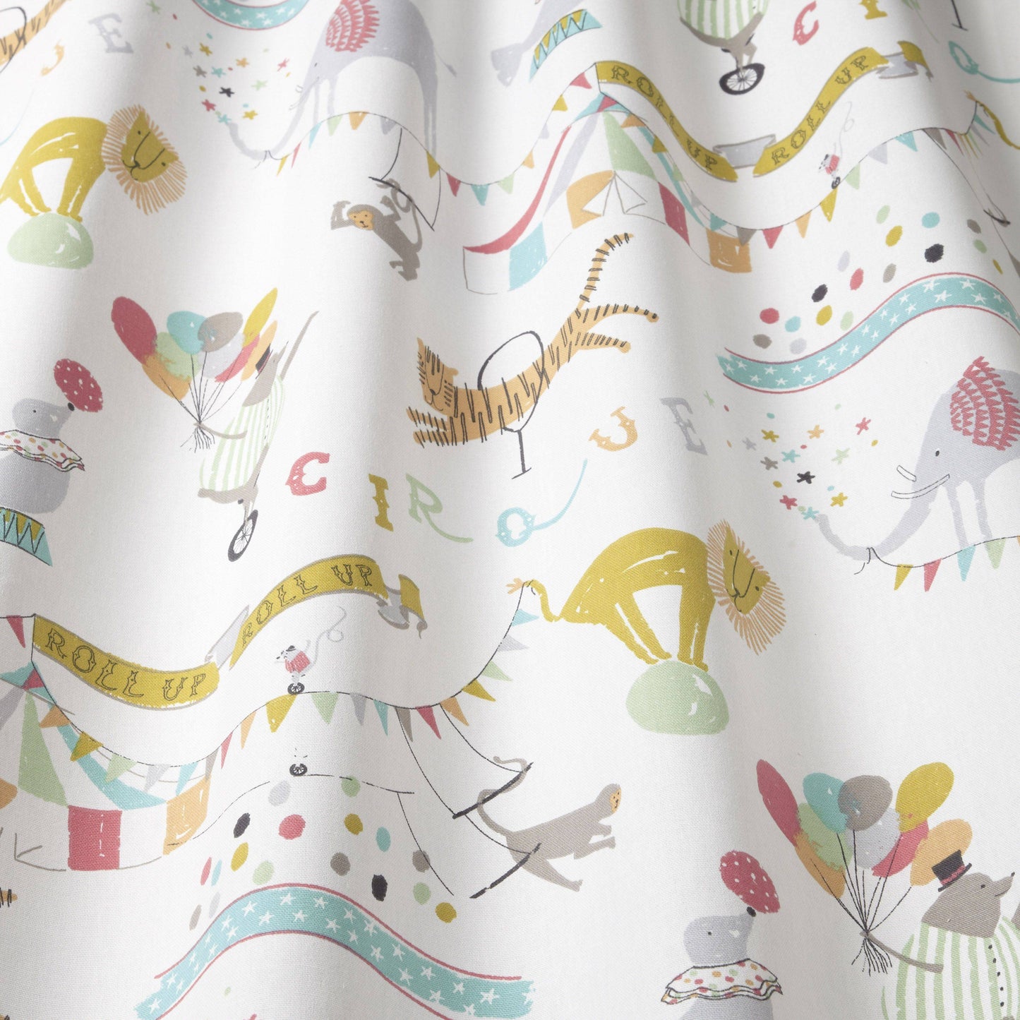 Close-up of Carnival Circus Multi fabric with vibrant circus-themed illustrations, perfect for kid's curtains, blinds, and playful textile projects.