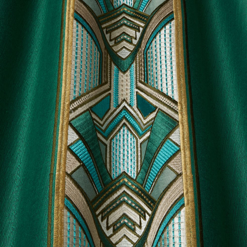 Close-up of Chrysler Art Deco Emerald fabric highlighting detailed embroidery with geometric patterns in teal, gold, and cream on rich velvet.
