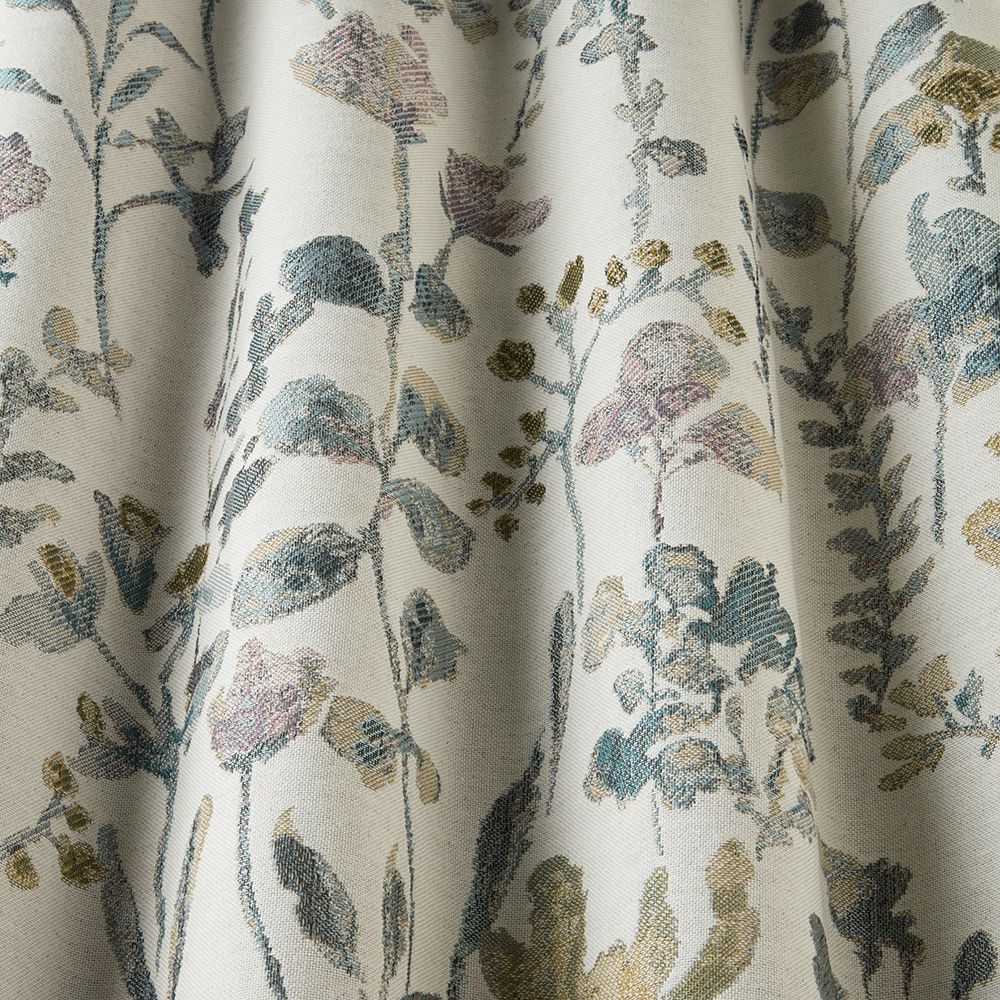 Close-up of Floral Croft Cornflower fabric displaying its intricate blue and pastel floral jacquard pattern with a textured finish.