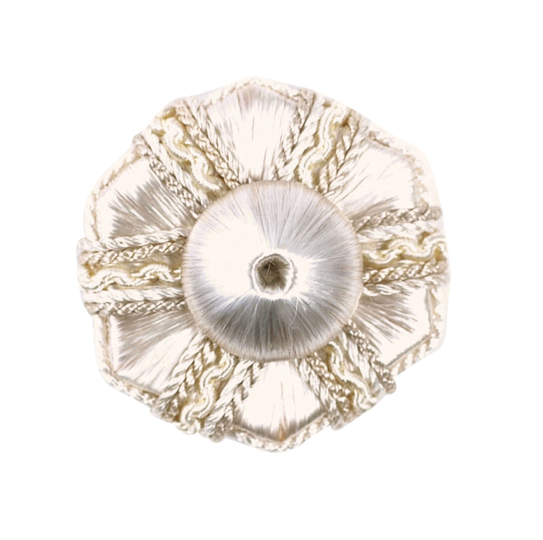 Decorative white rosette with gold accents on a white background
