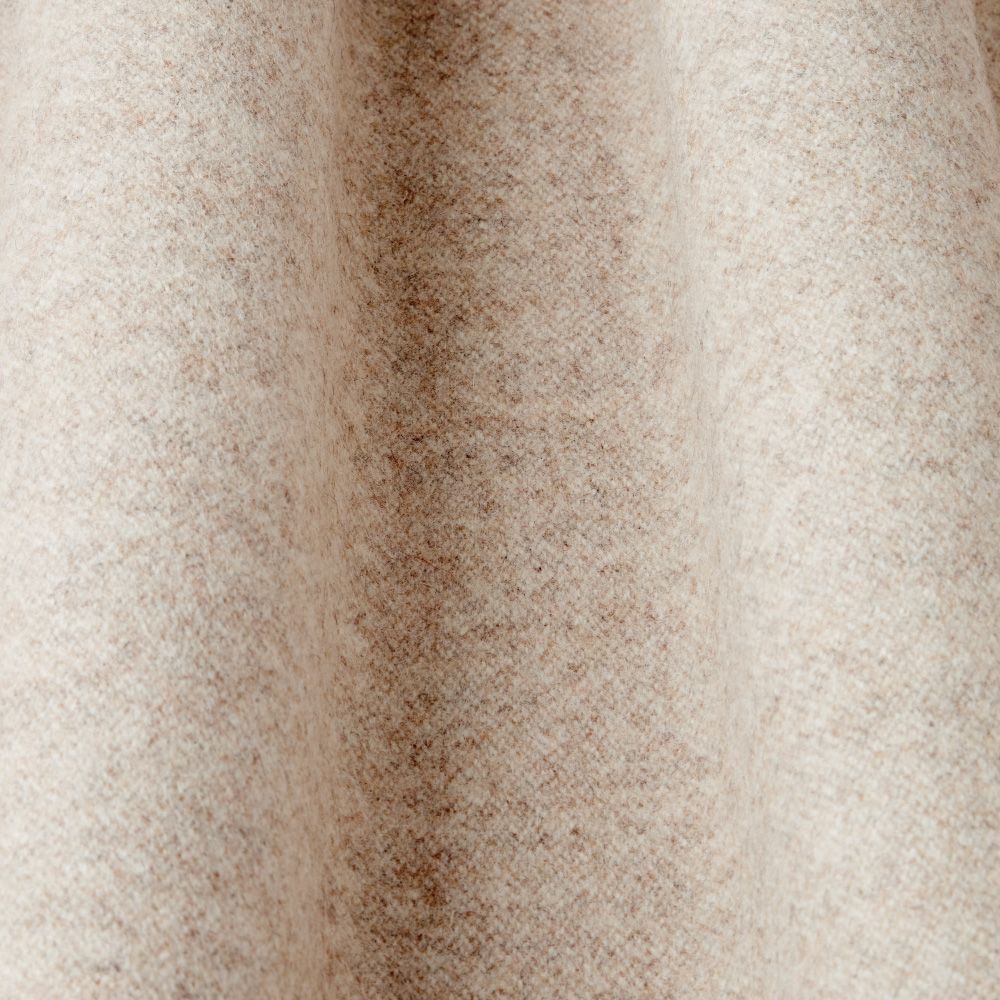 Close-up of a textured beige wool fabric