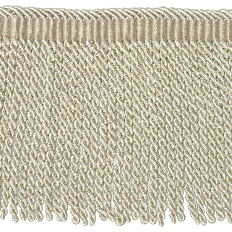Close-up of beige fabric fringe on a white background