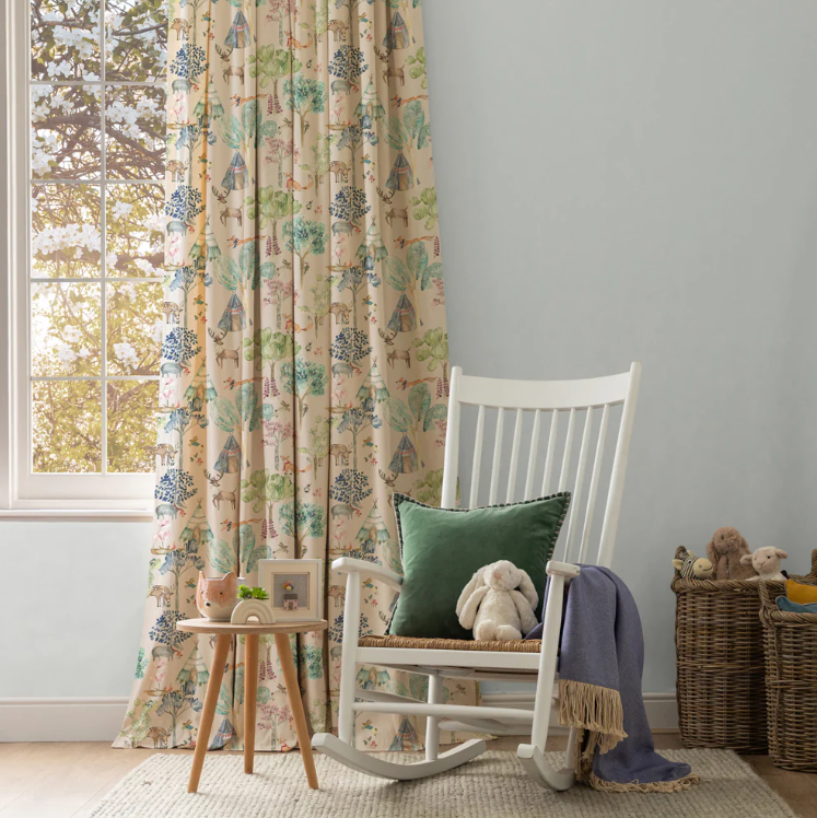 Kids' bedroom styled with Junior Forest Fabric Oat curtains, showcasing woodland animals and trees. Complements cosy and playful decor.