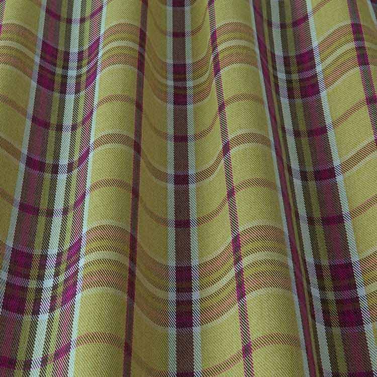 Close-up of Glenmore Contract Check Olive tartan fabric showcasing its green and purple plaid design and durable, stain-resistant texture.