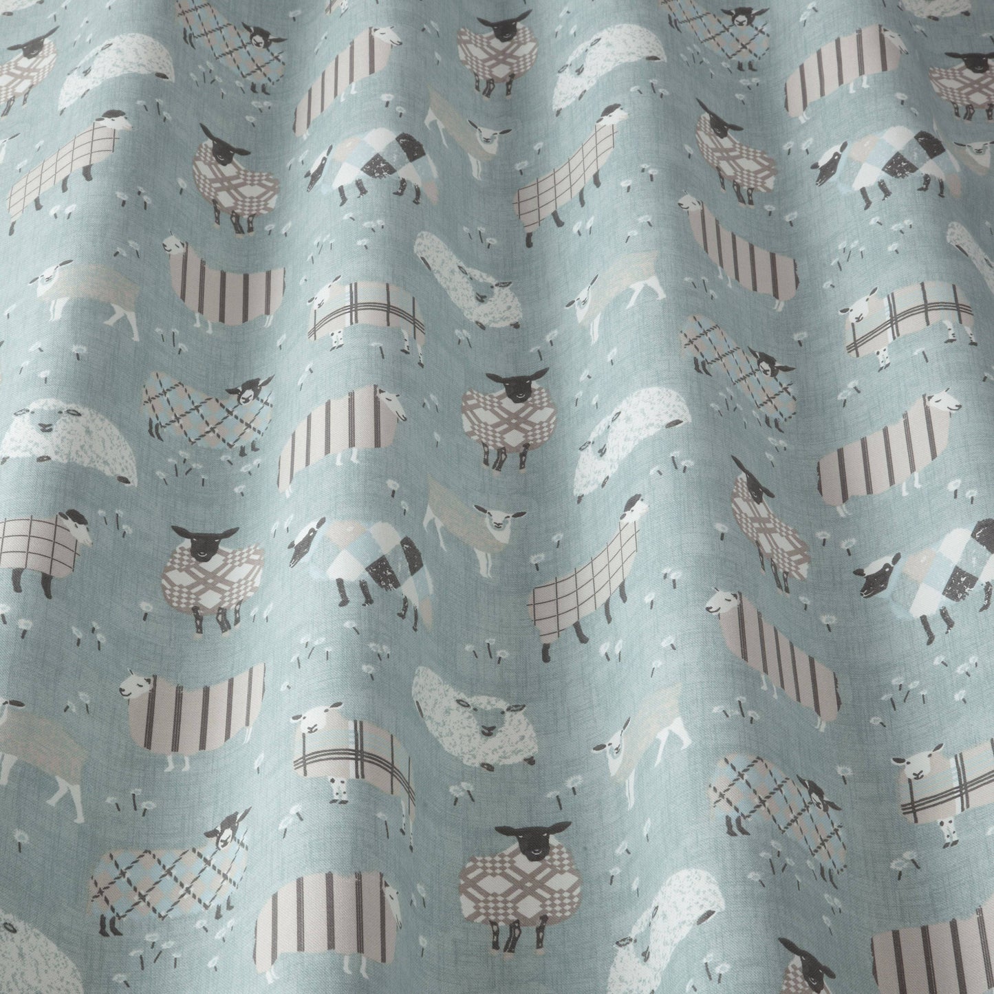 Close-up of Grazing Pastures Duck Egg fabric with cartoon sheep design, suitable for kids’ curtains, blinds, or upholstery projects.