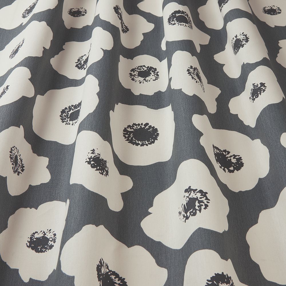 Close-up of Large Poppy Carbon fabric showcasing vibrant white poppies on a grey cotton base, perfect for creative arts and home projects.