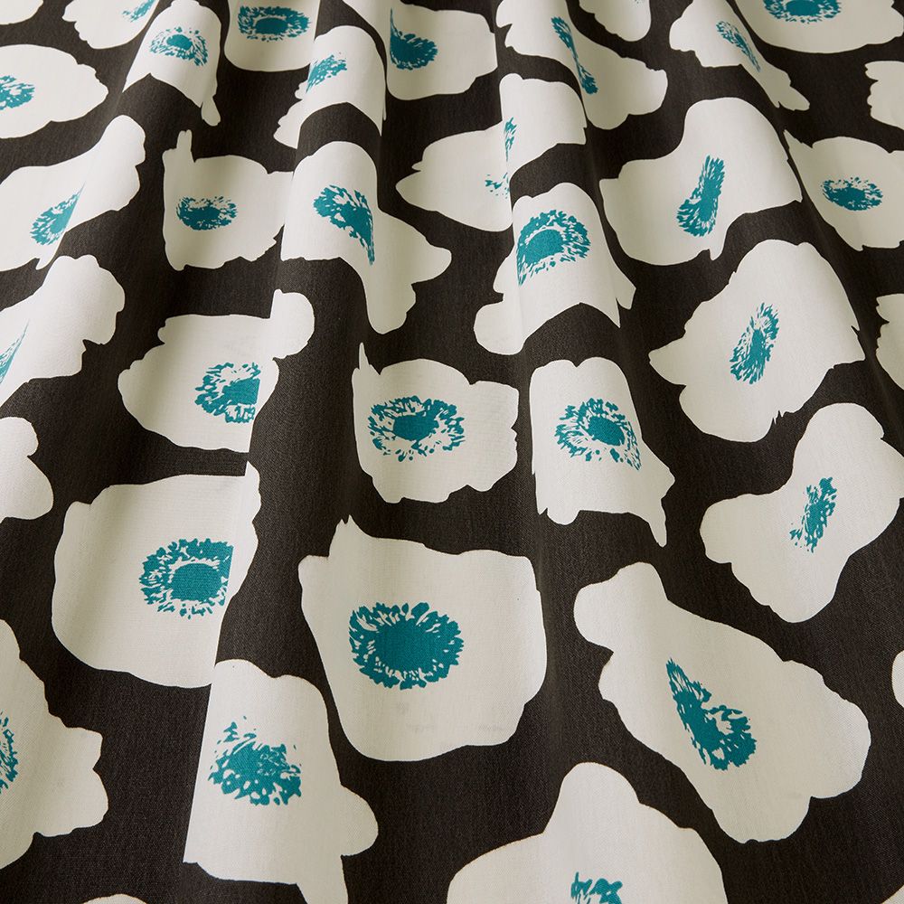 Close-up of Large Poppy Chocolate fabric showcasing its bold white and teal floral design on a dark brown cotton textile, perfect for crafts.