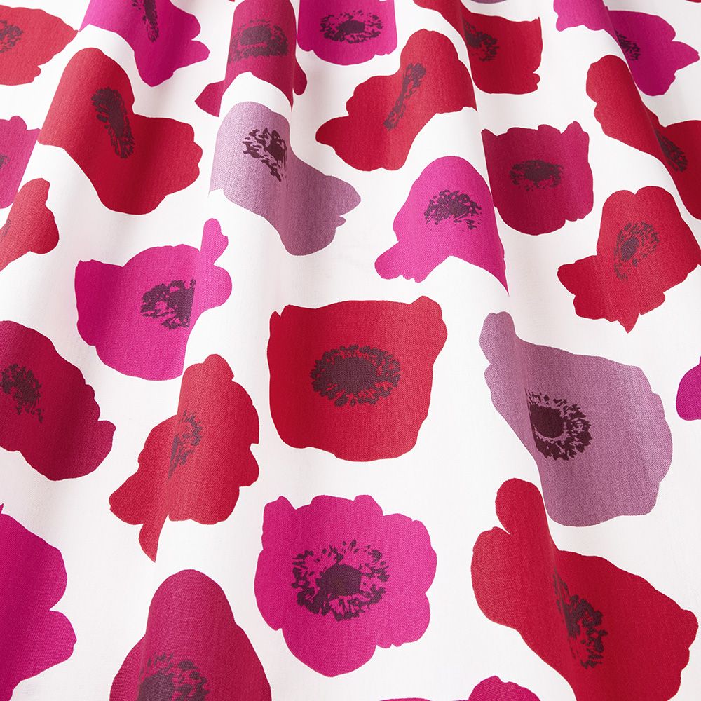 Close-up of Large Poppy Bloom Scandi fabric featuring bold red and pink floral cotton print, highlighting its vibrant and detailed design.