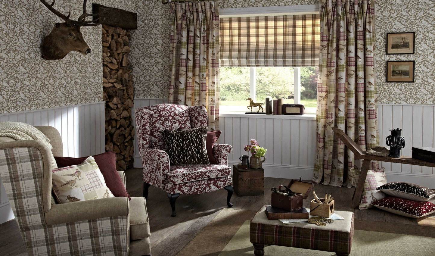 Living room with curtains and armchair upholstered in William Morris style Moor Rouge fabric, showcasing floral and animal patterns.