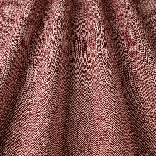 Close-up of a textured fabric with a herringbone pattern in shades of brown.