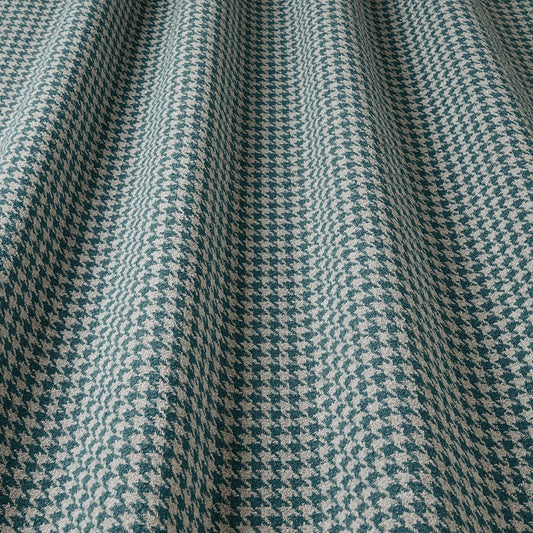 Close-up of a houndstooth patterned fabric in blue and beige.