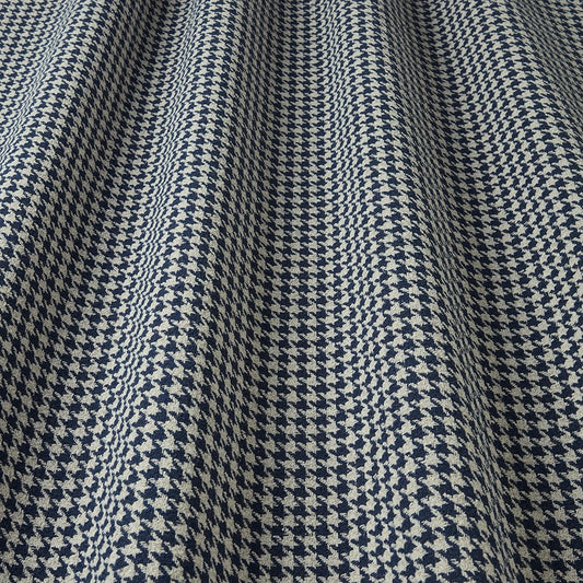 Close-up of a houndstooth patterned fabric in blue and white.