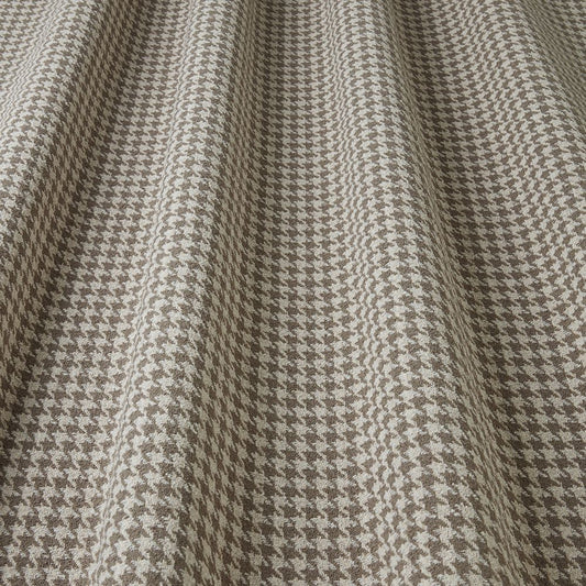 Close-up of houndstooth pattern fabric in brown and beige.