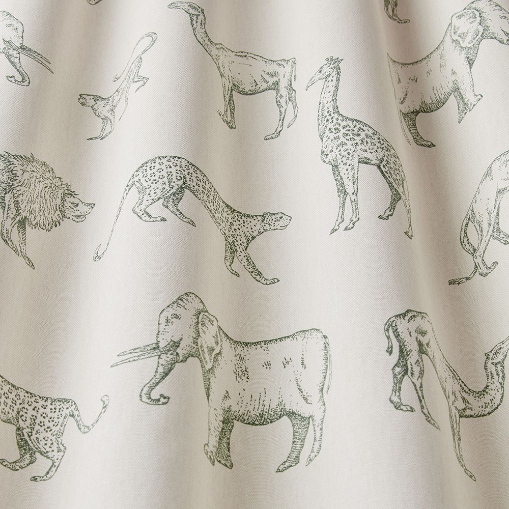 Close-up of African Safari Evergreen cotton fabric showcasing detailed hand-drawn animals, including elephants, giraffes, and cheetahs, on a soft green base.
