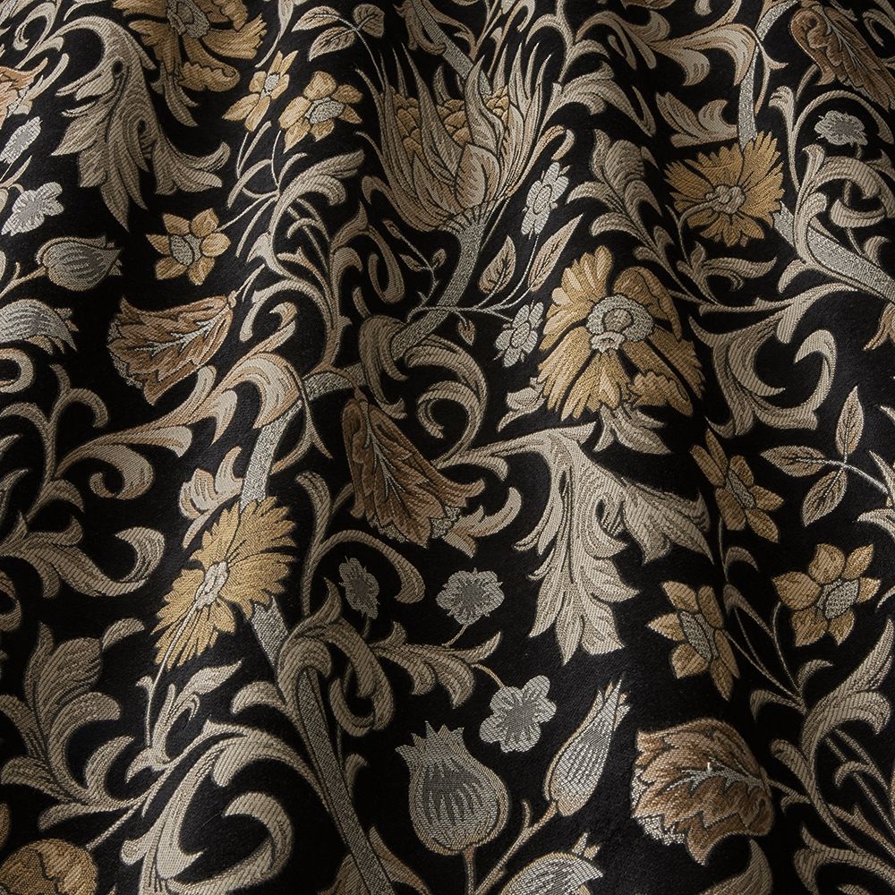 Saint Giles Saffron fabric with intricate arts and crafts floral patterns in gold and beige tones on a black background, ideal for curtains.