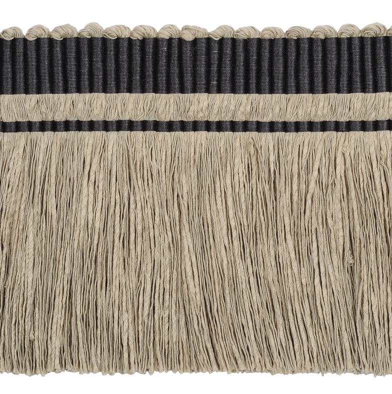 Close-up of a decorative trim with black and beige fringes on a white background