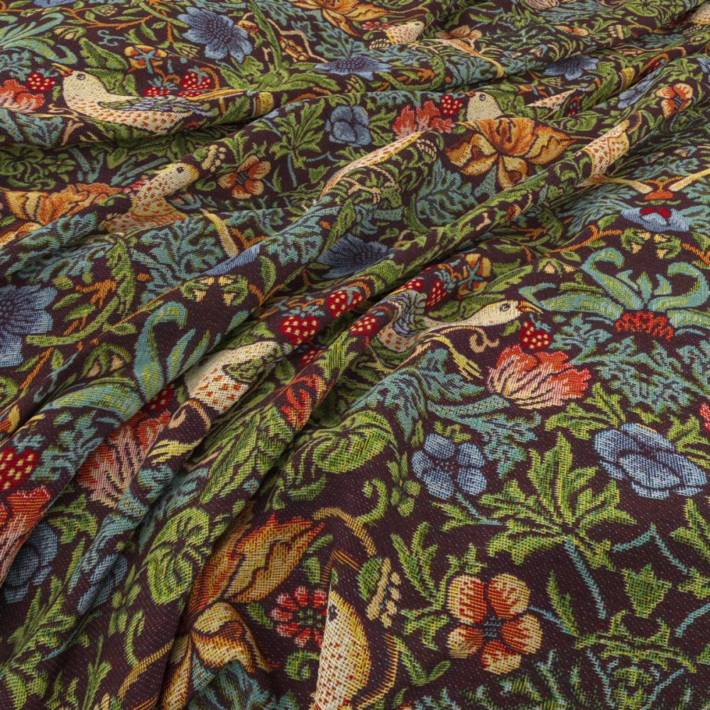 Close-up of William Morris Tapestry Strawberry Thief fabric in ebony, showcasing detailed bird and floral designs on a textured textile.