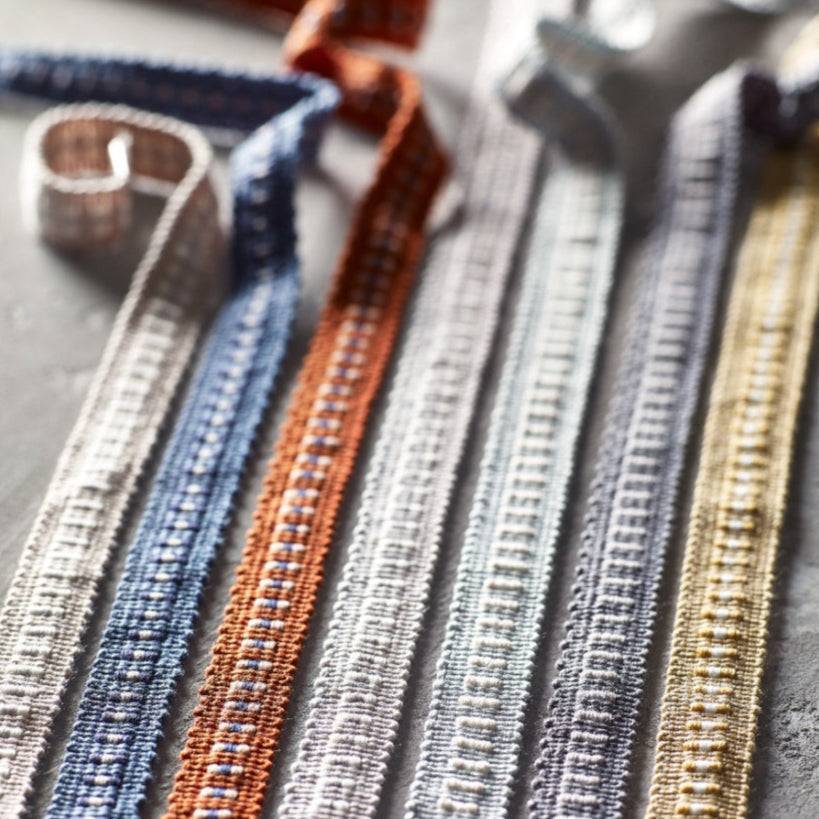 Assorted Laura Ashley Narrow Braid Trims in multiple colors including steel grey, perfect for enhancing furnishings with stylish and refined finishes.