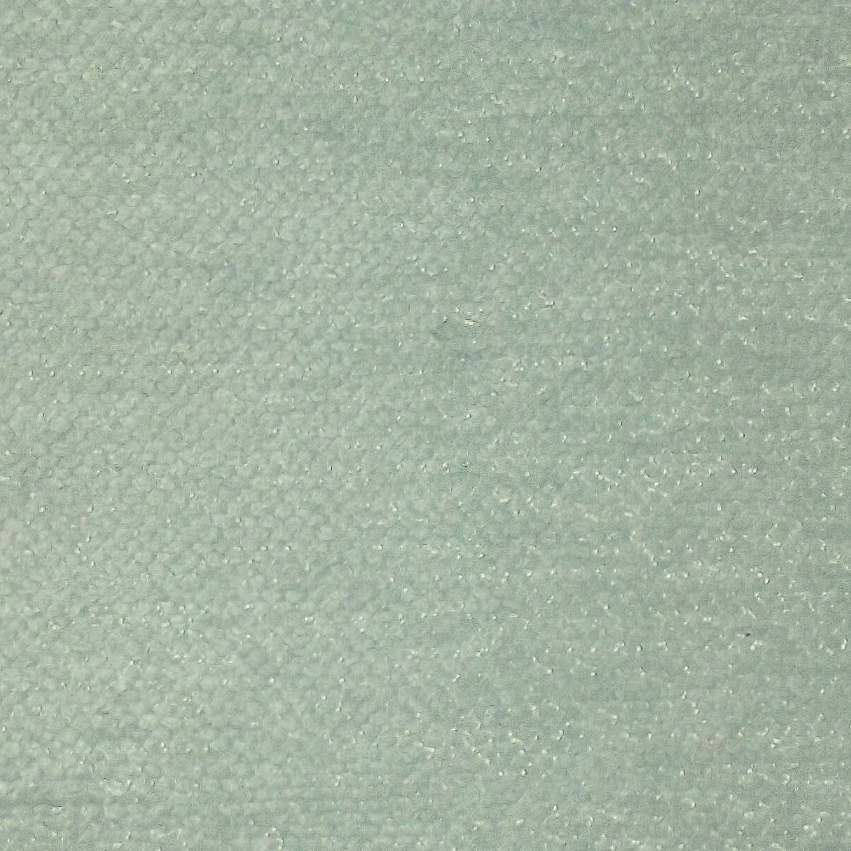 A close-up of a light sage green textured fabric with a subtle woven pattern.
