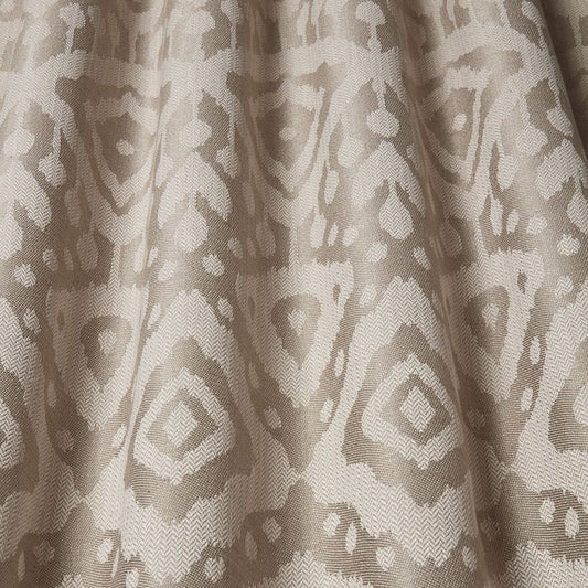 Axum Woven Jacquard Almond fabric with intricate Ikat pattern in earthy almond tones, ideal for upholstery and home decor projects.