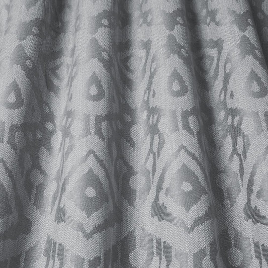 Axum Woven Jacquard Stone fabric showcasing intricate Ikat patterns in soft earthy tones, ideal for upholstery and home decor projects.