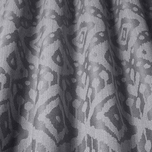 Axum Woven Jacquard Charcoal fabric with intricate Ikat-inspired patterns in earthy tones, ideal for upholstery and home decor projects.