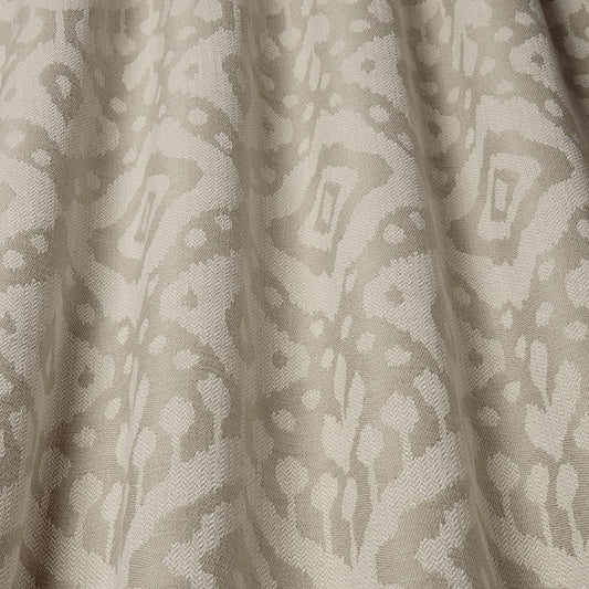 Axum Woven Jacquard Sand fabric showcasing a textured Ikat pattern in soft earthy tones, ideal for upholstery and home decor projects.