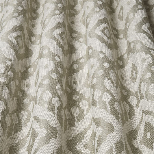 Axum Woven Jacquard Sage fabric with intricate Ikat-inspired patterns in soft sage and cream tones, perfect for upholstery and home decor.