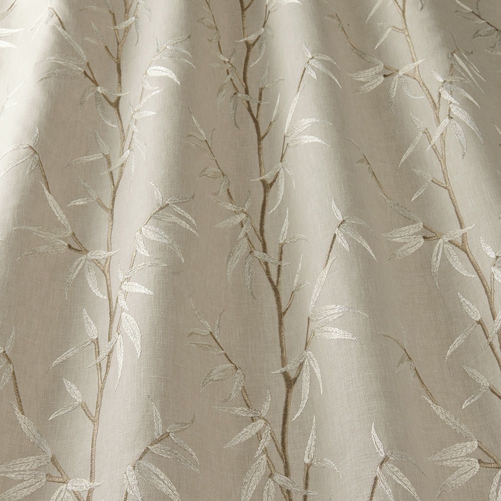 Close-up of Sakura Bamboo Cornsilk fabric showcasing detailed embroidery of bamboo leaves on a soft cream polyester-cotton blend for elegant interiors.