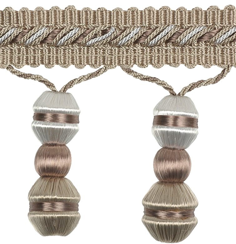 Decorative trim with braided design and spherical beads on a white background