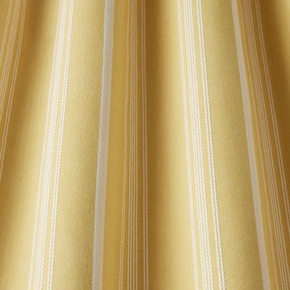 Close-up of Benedict Woven Stripe Barley fabric showing soft drape and textured yellow stripe pattern, perfect for classic curtain designs.