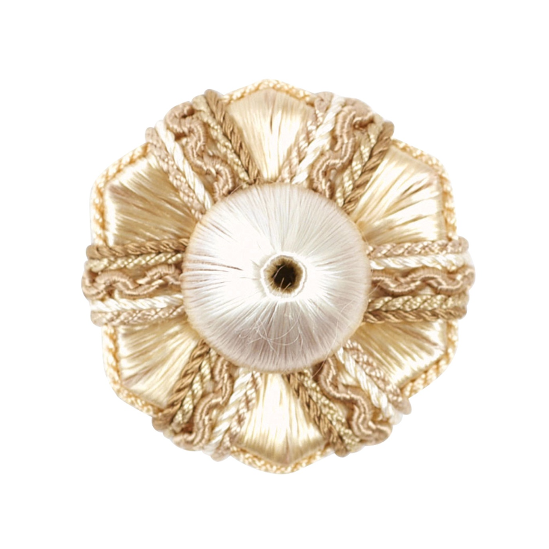 Decorative rosette with gold and white design on a white background