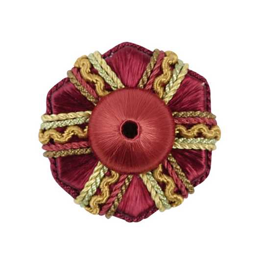 Decorative red and gold rosette on a white background
