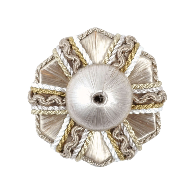 Decorative rosette with intricate grey and silver design on a white background