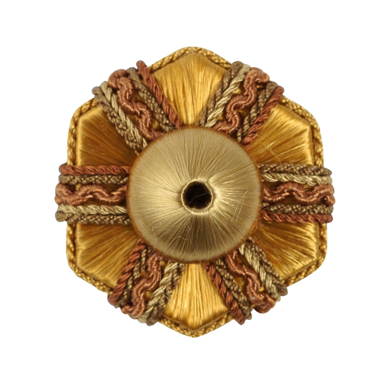 Decorative gold rosette with braided trim on a white background