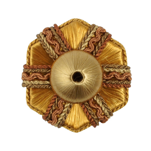 Decorative gold rosette with braided trim on a white background