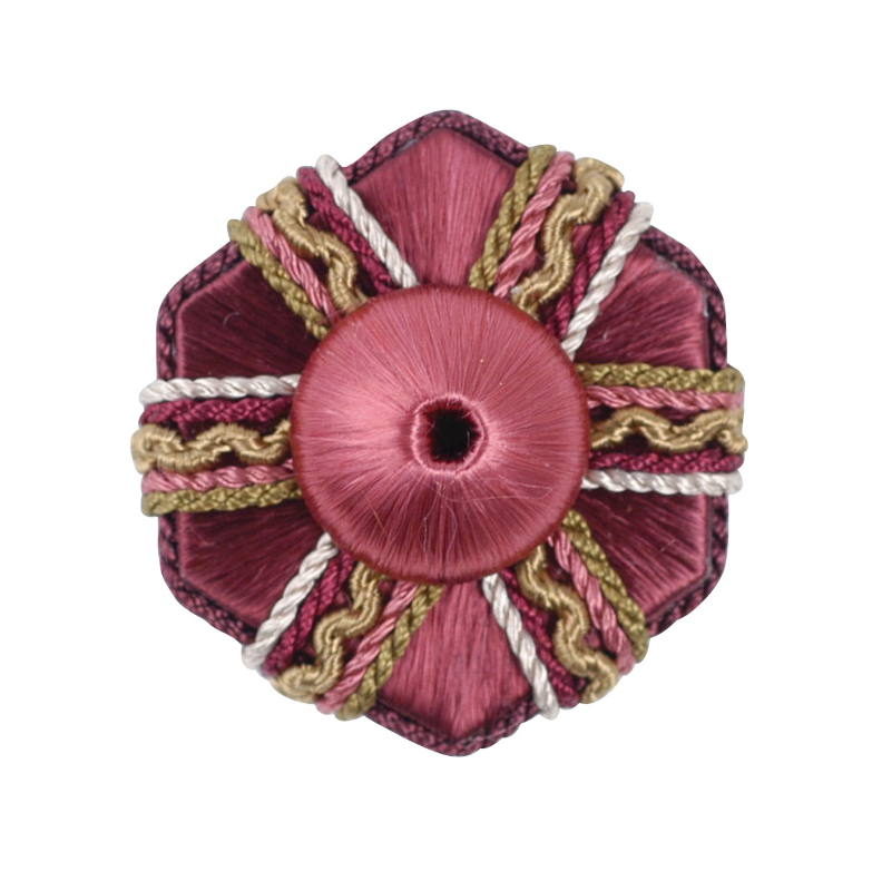 Decorative rosette with pink centre and braided trim on a white background