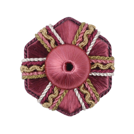 Decorative rosette with pink centre and braided trim on a white background