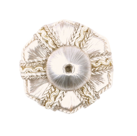 Decorative white rosette with gold accents on a white background