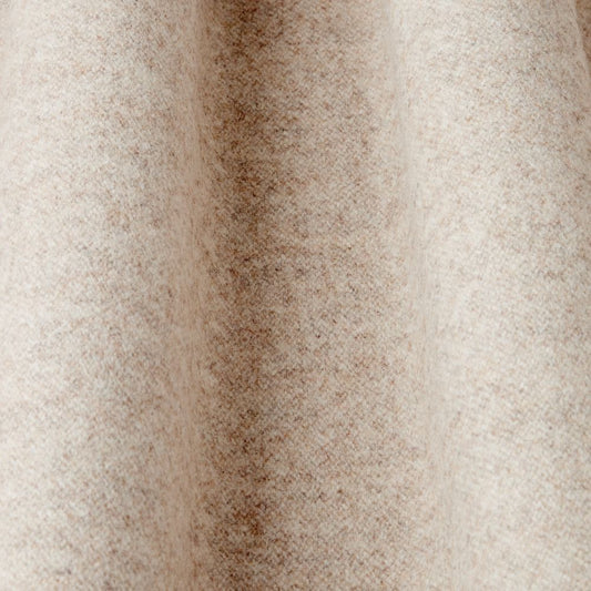 Close-up of a textured beige wool fabric 