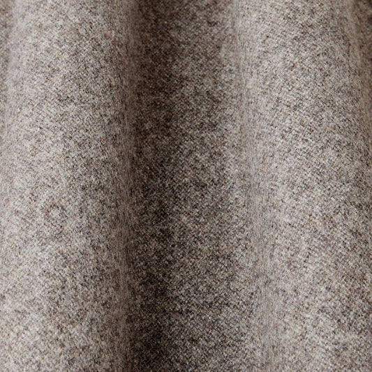 Close-up of textured brown fabric with a subtle pattern