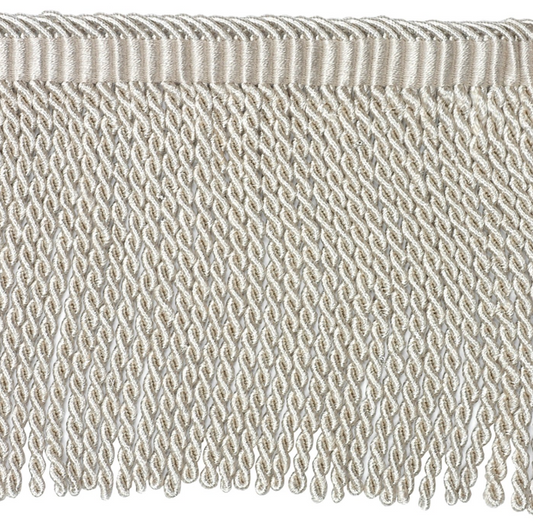 Close-up of textured bullion fringe trim detail on a white background