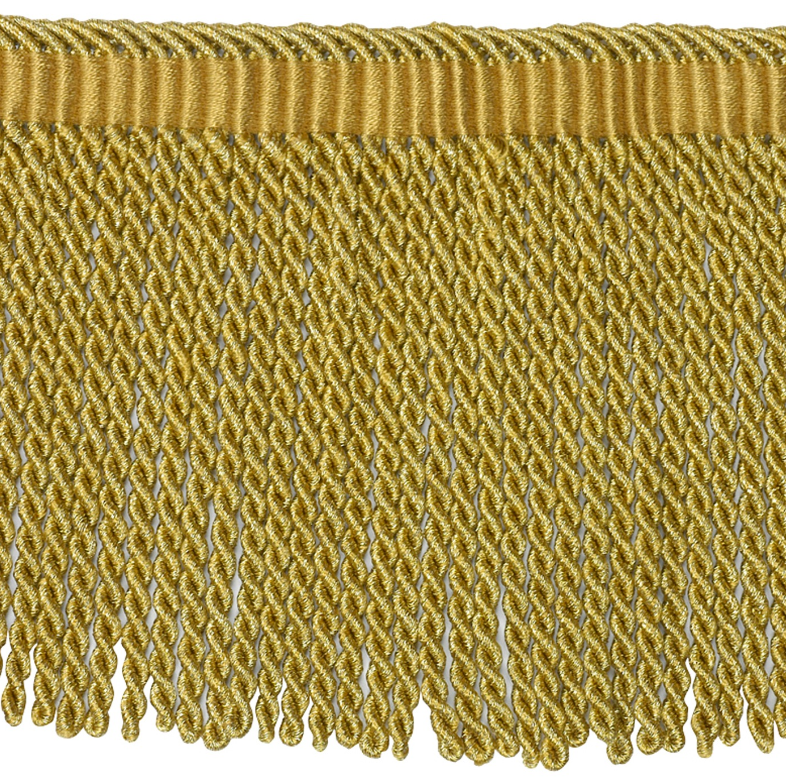 Gold fringe fabric trim on a white background