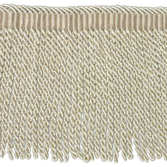 Close-up of beige fabric fringe on a white background