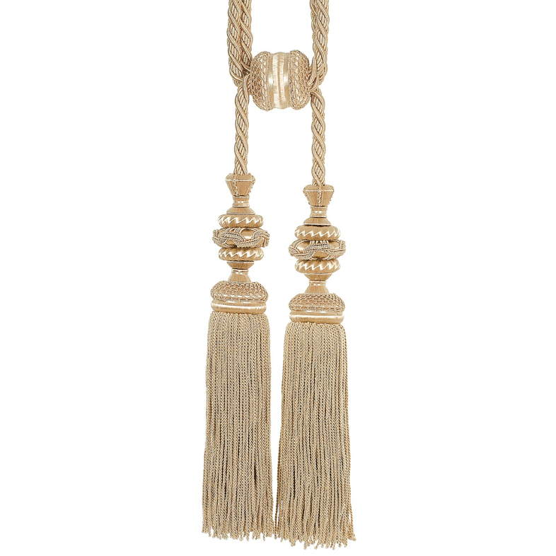 Decorative tassels with gold and beige elements on a white background