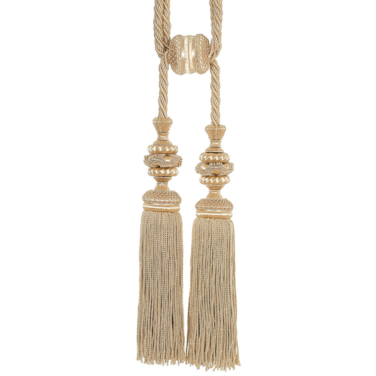 Decorative tassels with gold and beige elements on a white background