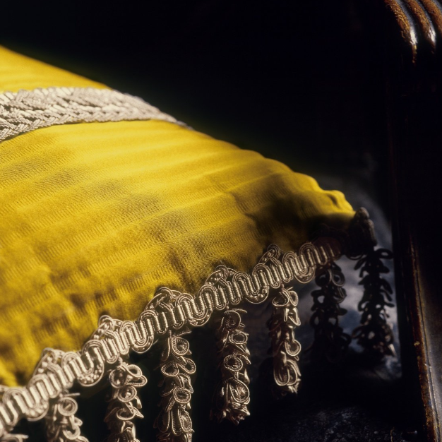 Close-up of a intricate silver embroidery on a dark background